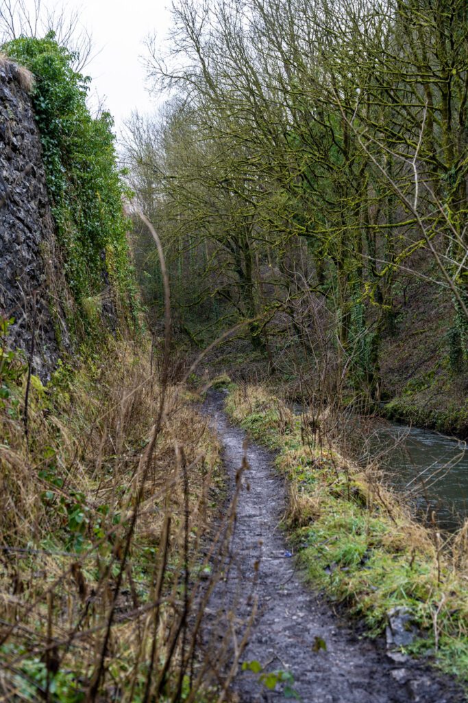 narrow riverside footpath with steep limestone gorge sides
