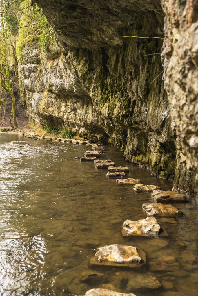 Stepping stones below limestone cliffs
