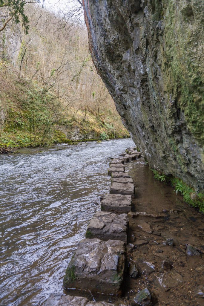 Large uniformed stepping stones beneath towering limestone cliffs