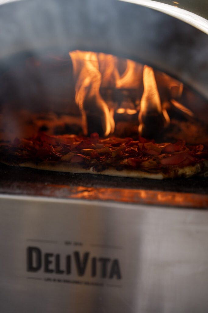 Wood fired pizza oven smoking and getting hot ready for cooking pizzas