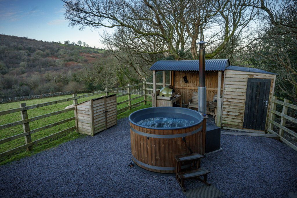 Wood fired hot tub and pizza oven outside a cosy shepherds hut in the Welsh countryside