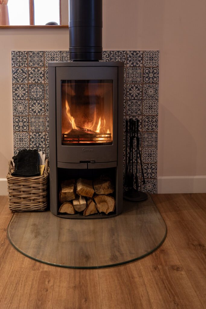 Log fire with under storage for logs, stone hearth and tiled back