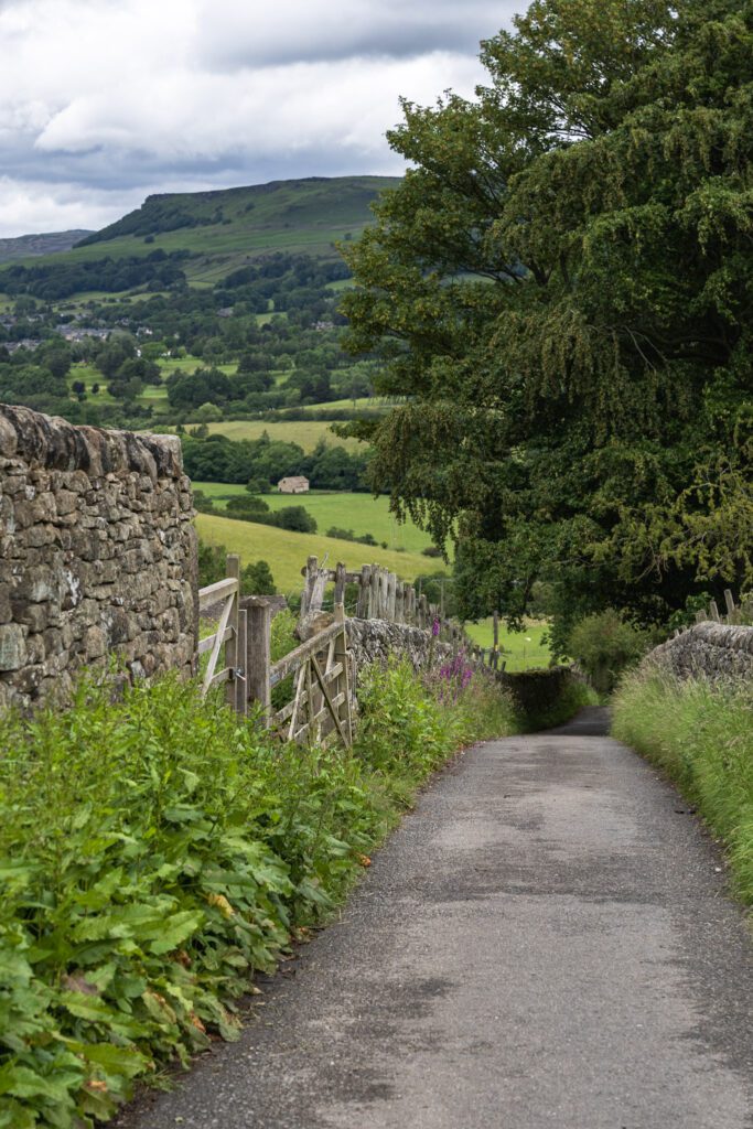 Country lane between two dry stone walls and views over the countryside