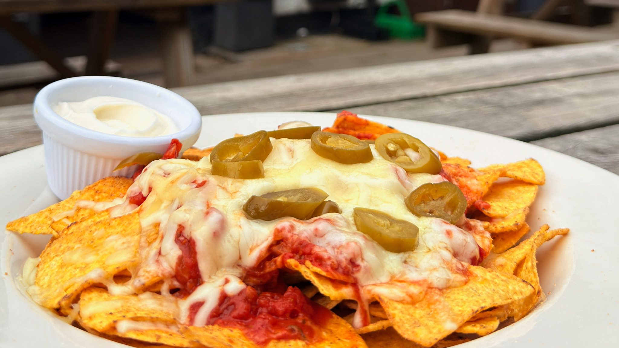 Nachos with cheese jalapeño's and salsa outside the George at Castleton on a pub bench