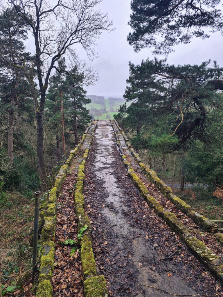 Disused aqueduct at Chatsworth looking towards the house and countryside
