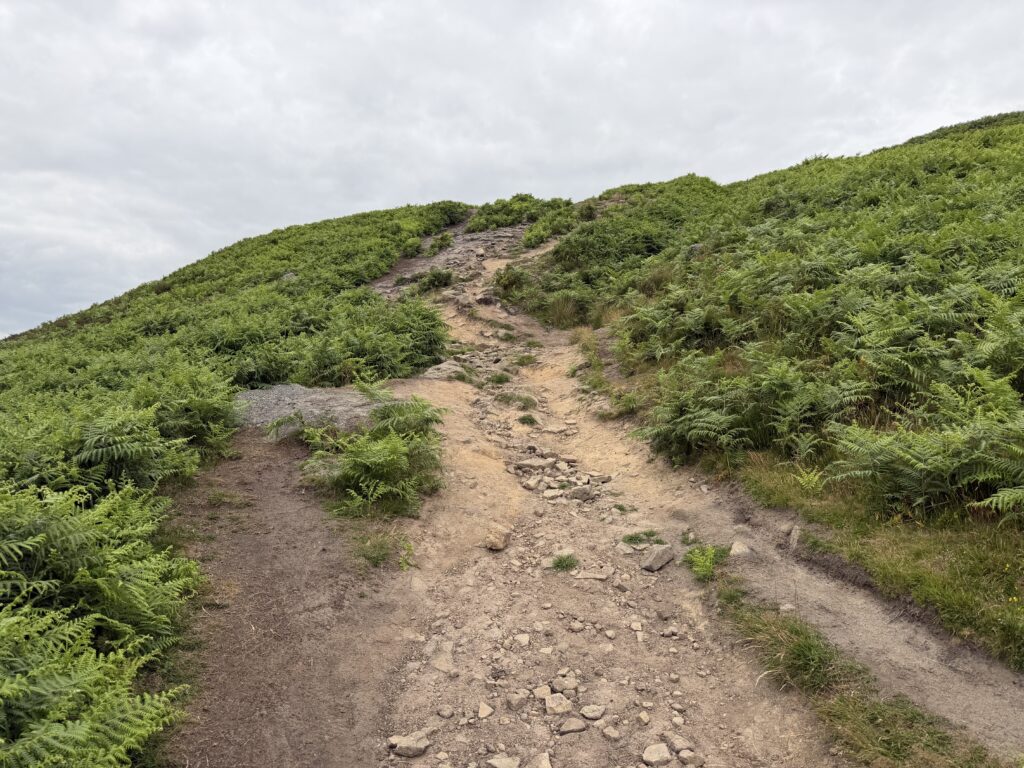 Steep dusty path with loose rocks up to Bamford Edge