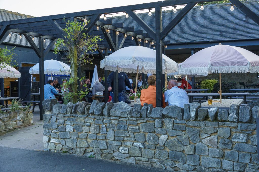 Beer garden being enjoyed by visitors in at dusk