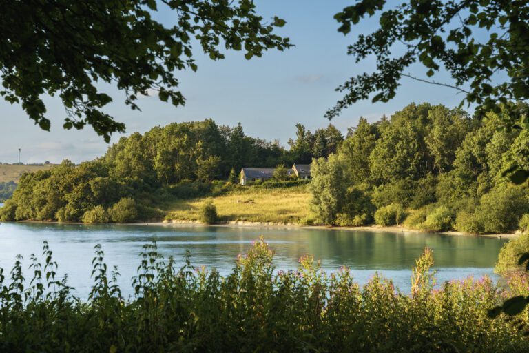 Views across Carsington water towards a farm complex