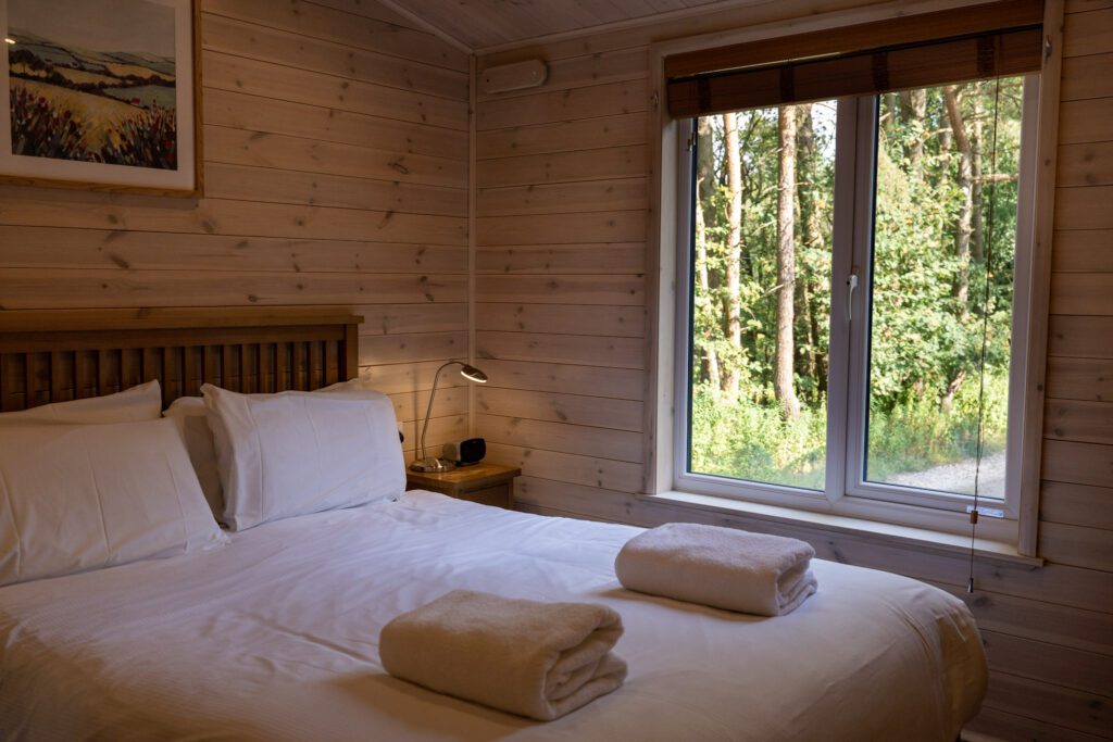 Double bed in our lodge with forest view
