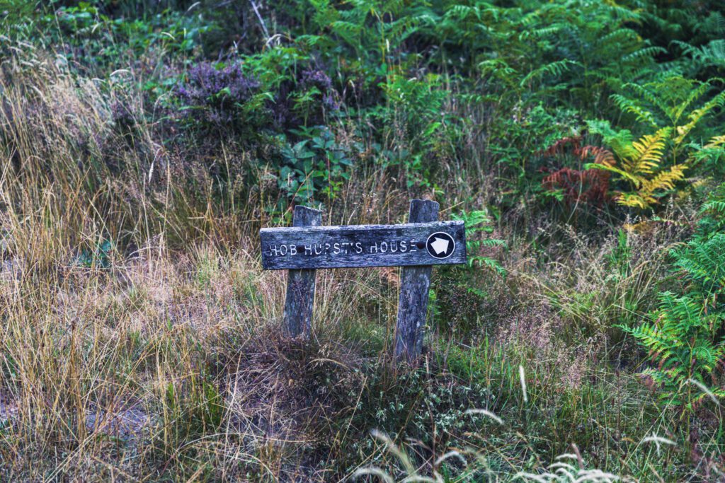 A footpath sign showing the way to Hob Hurst's House on the moorland