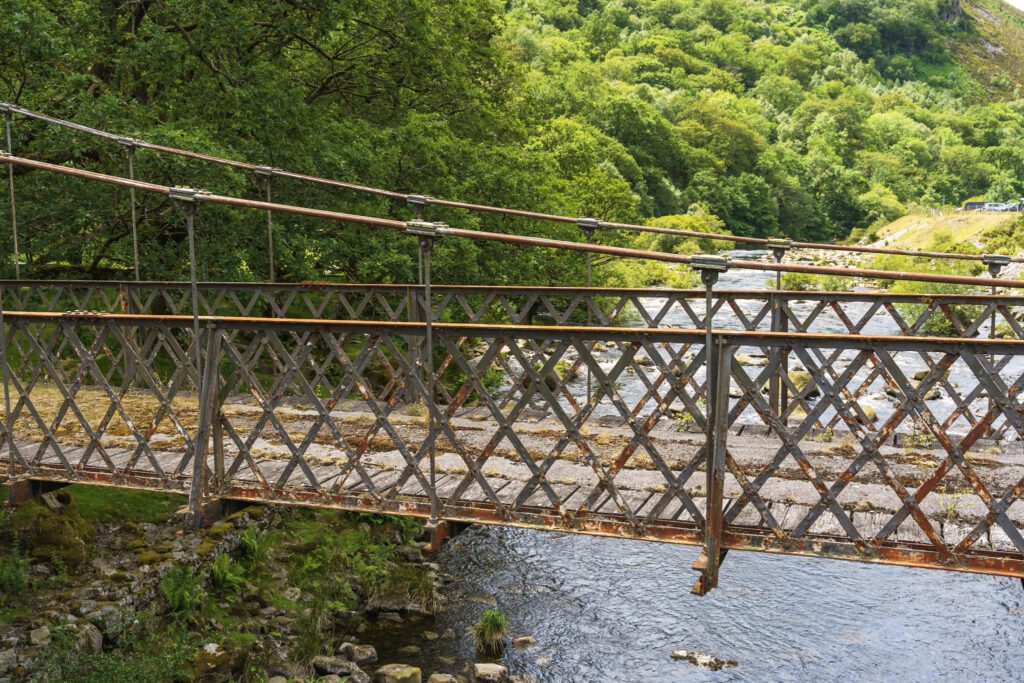 Old bridge over shallow river near Caban Coch Dam