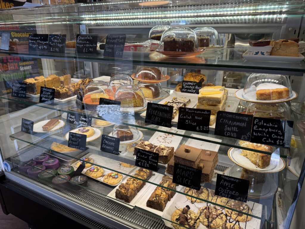 Cwtsh Bakery Display fridge full of cakes and bakes