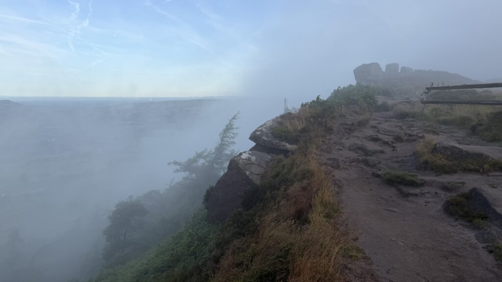 The roaches overlooking a steep drop in thick fog
