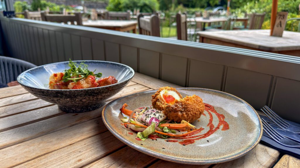 Scotch Egg and Crispy Pork belly starter on the table
