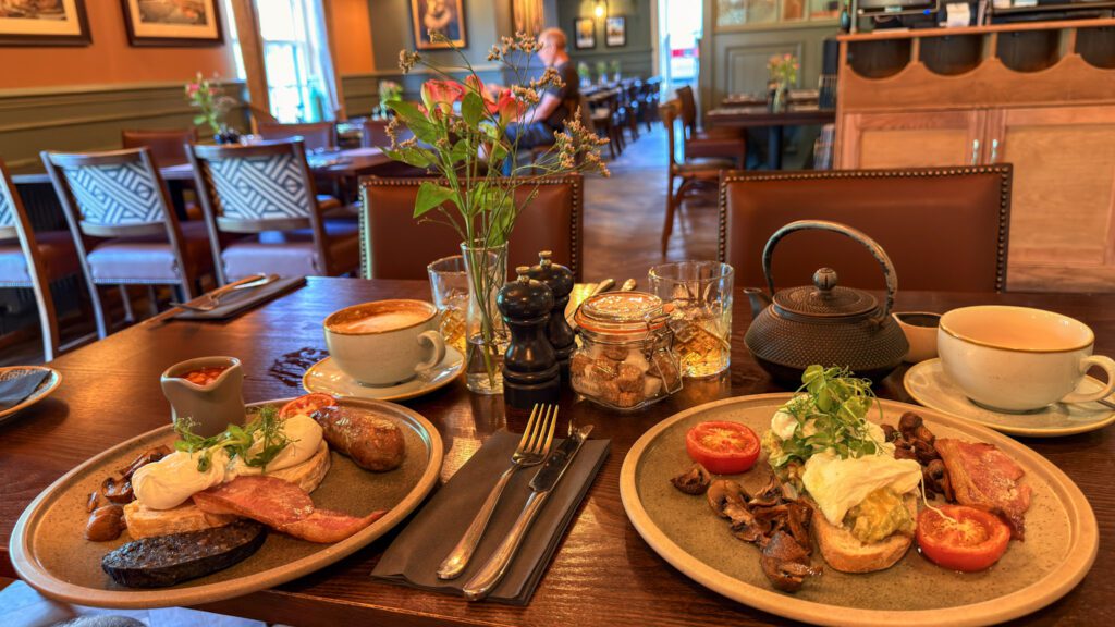 Full English breakfasts on table with drinks