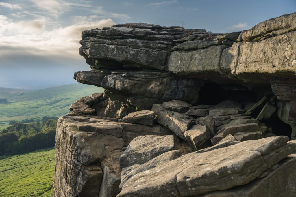 Balcony Cave on Stanage Edge and countryside behind it